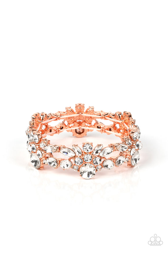 Crowned with an exquisite white rhinestone, stacks of round and marquise cut rhinestones coalesce into scintillating clusters. The glassy clusters of shiny copper frames are threaded along stretchy bands creating a dazzling display around the wrist.  Sold as one individual bracelet.