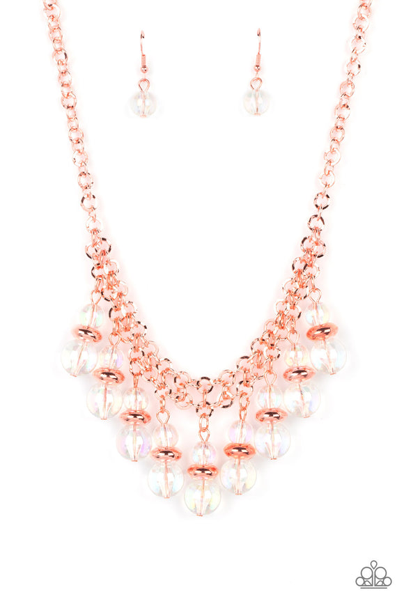 Featuring a stellar iridescence, pairs of glassy beads are separated by shiny copper discs, trickling below the collar in an effervescent fringe. Features an adjustable clasp closure. Due to its prismatic palette, color may vary.  Sold as one individual necklace. Includes one pair of matching earrings.