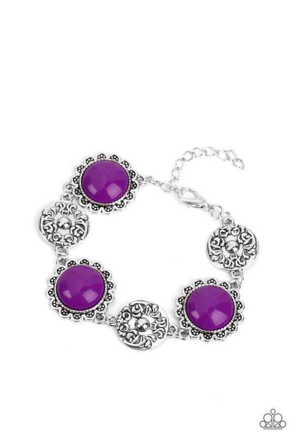 Shiny oversized Dahlia beads are wrapped in floral-inspired frames of silver, filled with studded texture. Silver discs embossed in a filigree motif alternate with the vibrant beads as they link around the wrist in a whimsical finish. Features an adjustable clasp closure.  Sold as one individual bracelet.