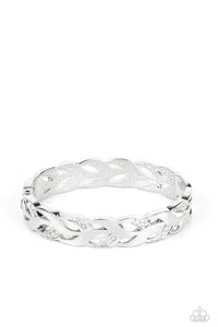 Folds of shiny silver and white rhinestone dotted silver frames delicately braid around the wrist, creating a leafy bangle-like bracelet. Features a hinged closure.  Sold as one individual bracelet.