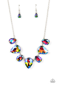 Featuring a stellar iridescence, an oversized collection of glittery blue teardrop gems alternates upside down and right-side up below the collar for an out-of-this-world sparkle. Features an adjustable clasp closure. Due to its prismatic palette, color may vary.  Sold as one individual necklace. Includes one pair of matching earrings.