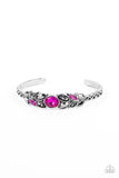 A large magenta rhinestone is set in a rounded silver frame and set atop a skinny silver cuff. Marquise shaped pieces of hematite, magenta rhinestones and rhinestones in the same smoky hue fan out from the center in a leafy pattern, giving way to bars of silver adorned in chain link texture.   Featured inside The Preview at GLOW! Sold as one individual bracelet.