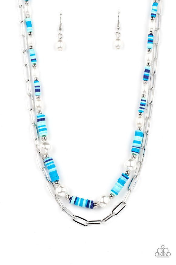 Sections of colorful rubber discs in shades of blue, turquoise, and navy are separated by tiny silver beads and a variety of white baroque pearls to create an unexpected mashup of texture along the collar. A strand of silver paperclip link chain is paired with the abstract design in a layered finish. Features an adjustable clasp closure.   Featured inside The Preview at GLOW! Sold as one individual necklace. Includes one pair of matching earrings.  New Kit