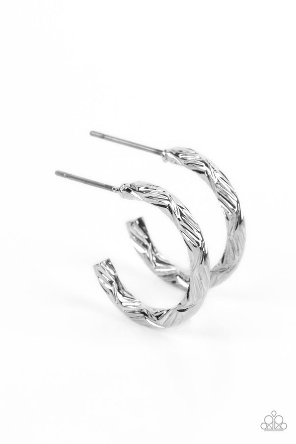 A delicate band of silver is etched in linear textures, curling around the ear to create a small, classic hoop. Earring attaches to a standard post fitting. Hoop measures approximately 1/2