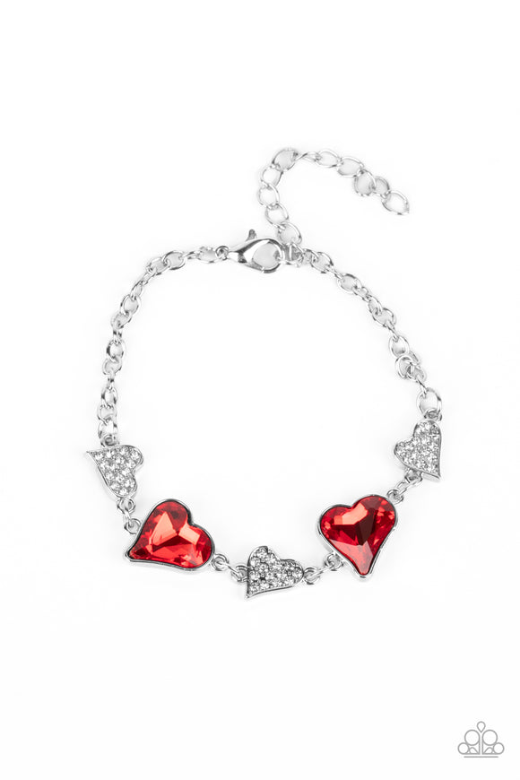 An asymmetrical collection of hearts coalesce around the wrist in this flirty centerpiece. Three of the silver hearts are encrusted with dainty white rhinestones, while the other two heart frames boast rich, red gems for a sparkly finish. Features an adjustable clasp closure.  Sold as one individual bracelet.