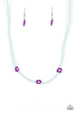 Strung along the entirety of an invisible wire, light blue seed beads coalesce around the collar. The row of blue seed beads are haphazardly interrupted by blooming purple seed bead flowers, with baby pink seed bead centers for a carefree, charismatic finish. Features an adjustable clasp closure.  Sold as one individual necklace. Includes one pair of matching earrings.