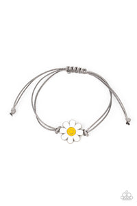 Held together and centered within soft gray cording, a single daisy charm rests. Featuring a silver smiley face in its yellow center, this single flower provides a fashionably, minimalistic statement around the wrist. Features an adjustable sliding knot closure.  Sold as one individual bracelet.