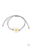 Held together and centered within soft gray cording, a single daisy charm rests. Featuring a silver smiley face in its yellow center, this single flower provides a fashionably, minimalistic statement around the wrist. Features an adjustable sliding knot closure.  Sold as one individual bracelet.