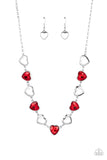 Shiny, silver silhouette hearts alternate between faceted red heart gems pressed into silver frames.The high-sheen and sparkly display coalesce around the collar for a cupid-like charm. Features an adjustable clasp closure.  Sold as one individual necklace. Includes one pair of matching earrings.