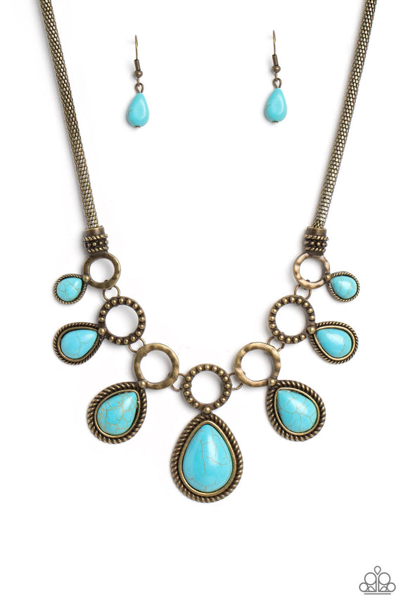 An airy mesh chain gives way to a collection of brass rings that link along the collar. A rustic dot motif decorates three of the rings, alternating with the remaining hoops that feature a subtle hammered texture. A polished turquoise stone teardrop falls from each brass hoop, graduating in size as they lead to the center. Features an adjustable clasp closure. As the stone elements in this piece are natural, some color variation is normal.  