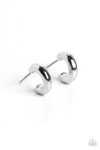 A deceptively simple dainty hoop of silver smoothly curves around the ear. The thick, chunky surface of the hoop catches the light, emitting radiant shimmer from the crescent-shaped curves. Earring attaches to a standard post fitting. Hoop measures approximately 1/4" in diameter.  Sold as one pair of hoop earrings.