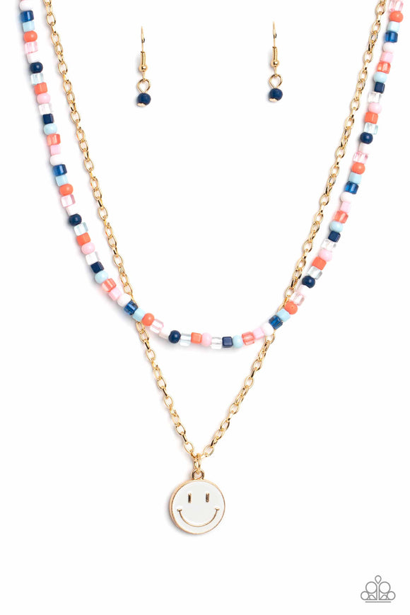 Gliding from a dainty, gold chain, a smiley face pendant stands out against a white backdrop. Completing the charismatic ensemble, a collection of seed beads in shades of Spun Sugar, baby pink, navy blue, white, and coral create bright pops of color around the neckline for a youthful finish. Features an adjustable clasp closure.  Sold as one individual necklace. Includes one pair of matching earrings.