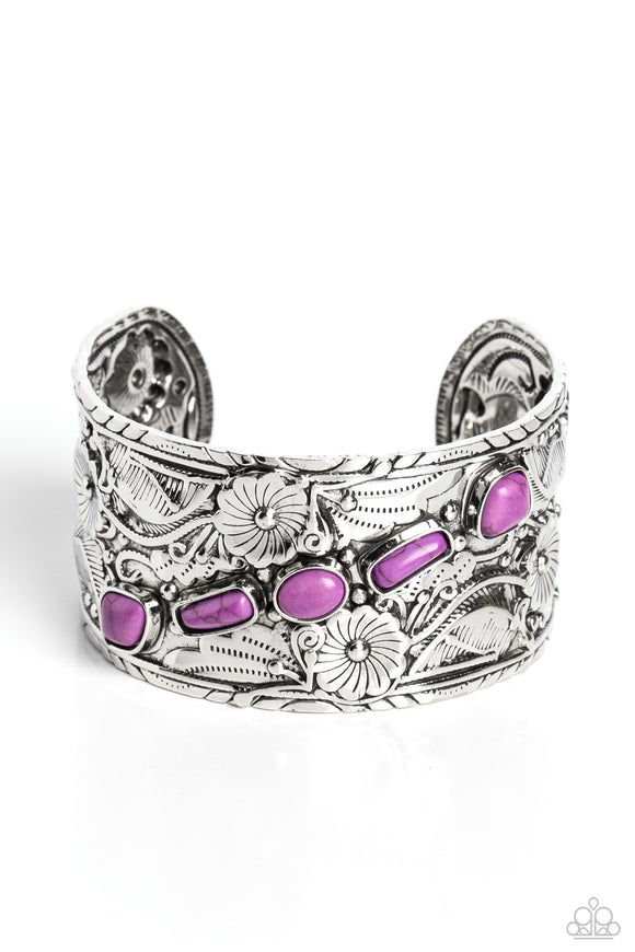 Featuring an embossed floral-detailed finish, a thick silver cuff is haphazardly interrupted with a collection of stones in various shapes for a seasonal, earthy look. Pressed into silver, geometric frames, purple stones diagonally cross the cuff for a funky pop of color across the wrist. As the stone elements in this piece are natural, some color variation is normal.  Sold as one individual bracelet.