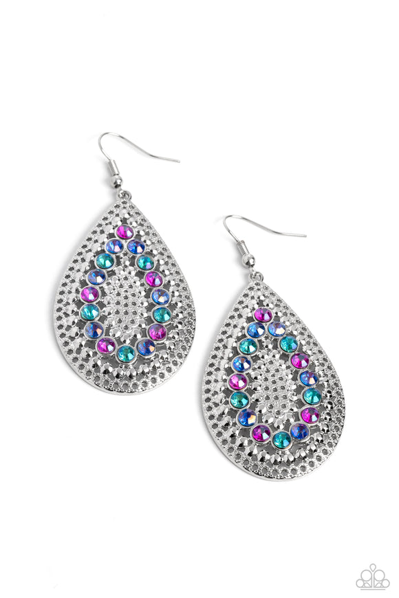 Set against an airy, dot motif backdrop, faceted purple and various shades of blue rhinestones curve into a teardrop shape atop an oversized silver teardrop lure, creating a dazzling pop of color near the ear. Earring attaches to a standard fishhook fitting.  Sold as one pair of earrings.