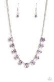 Infused along a dainty silver chain, purple gems glimmer around the collar. A trio of dainty iridescent and purple gems kiss the bottom curve of the bigger gems for additional light-catching shimmer and shine. Features an adjustable clasp closure. Due to its prismatic palette, color may vary.  Sold as one individual necklace. Includes one pair of matching earrings.