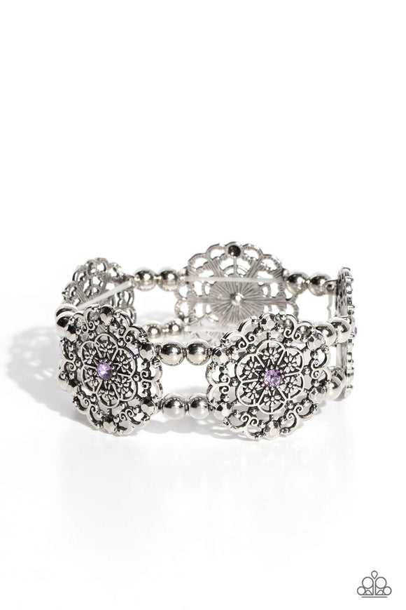 Dainty silver studs and floral details scatter across the fronts of airy medallions fashioned from whimsical floral-shaped filigree. Centered in each intricate design, purple rhinestones glimmer for a sparkly flourish. The splendid frames alternate along stretchy bands and silver beads resulting in a regally refined design that wraps around the wrist.  Sold as one individual bracelet