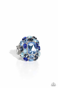 A faceted radiant-cut light blue gem is pressed into an elaborate silver frame filled with blinding oval-cut gems in varying shades and opacities of blue for a dynamically colorful statement atop the finger. Features a stretchy band for a flexible fit.  Sold as one individual ring.