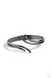 Brushed in a high-sheen finish, branches of gunmetal bands curl and overlap around the center of the wrist, creating a mystical centerpiece. Features a hinged closure.  Sold as one individual bracelet.