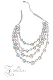 A dizzying display of silver hoops drapes across the chest in effervescent layers. Smooth, glassy beads, brushed in swirls of pastel iridescence, bubble up from some of the open, circular frames, further exaggerating their staggered size and placement, and showcasing their dreamy opalescent finish. With every new angle, a different hue emerges from the glassy beads, mimicking the reflective surface of water in a tropical paradise and emitting an air of serenity. Features an adjustable clasp closure. 