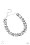 Featuring pronged silver fittings, strands of oversized, glittery white rhinestones connect with rows of silver box chains around the neck for a glittery twist. Features an adjustable clasp closure.  Sold as one individual choker necklace. Includes one pair of matching earrings.