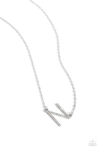 Embossed with dainty iridescent rhinestones, a silver letter "N" hovers below the collar from a dainty silver chain, for a sentimentally simple design. Features an adjustable clasp closure. Due to its prismatic palette, color may vary.  Sold as one individual necklace. Includes one pair of matching earrings.