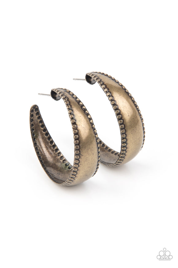 Bordered in a flattened studded pattern, an antiqued brass hoop curls into a dainty hoop for a rustic flair. Earring attaches to a standard post fitting. Hoop measures approximately 1 1/2
