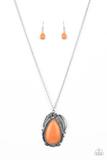 A silver feather, palm leaf, and dainty silver flower overlap atop an oversized orange stone teardrop that is nestled inside a textured scalloped frame, creating a dramatic pop of color at the bottom of a lengthened silver chain. Features an adjustable clasp closure. Sold as one individual necklace. Includes one pair of matching earrings.