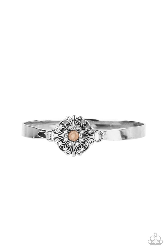 Dotted with a dainty orange cat's eye stone center, a silver floral filigree frame hinges to the center of a dainty silver cuff-like bangle for a whimsical finish. Features a hinged closure. Sold as one individual bracelet.