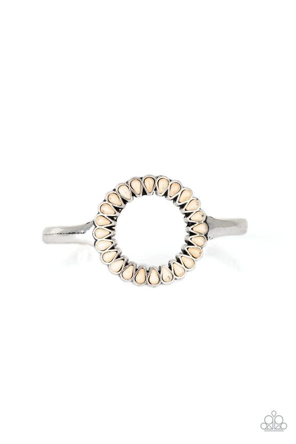 Chiseled into tranquil teardrops, refreshing white stones spin around the center of an antiqued silver cuff for a seasonal look.  Sold as one individual bracelet.